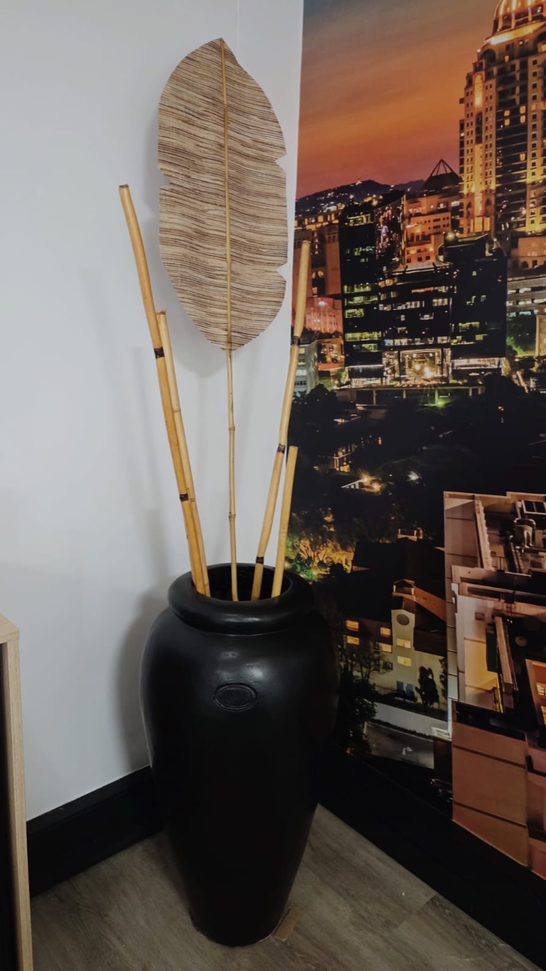 Completed decorative vase arrangement beside a custom city wall mural